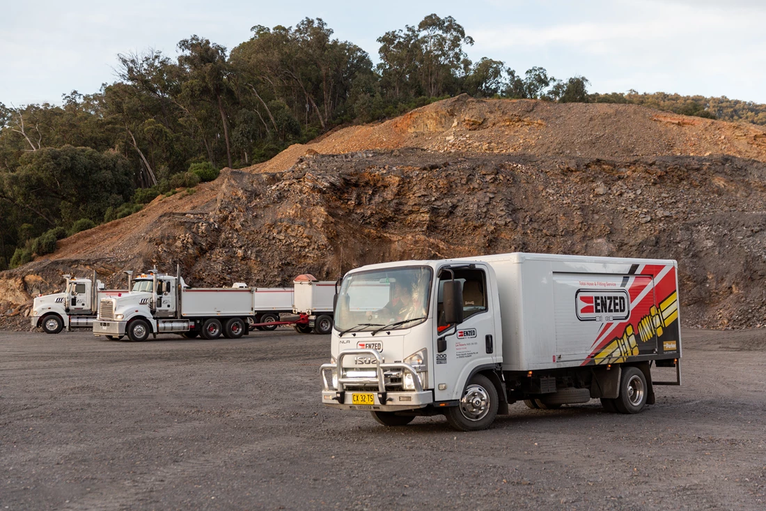 ENZED HOSE DOCTOR beside a service truck