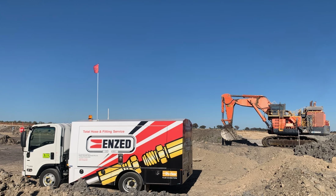 ENZED HOSE DOCTOR beside a service truck